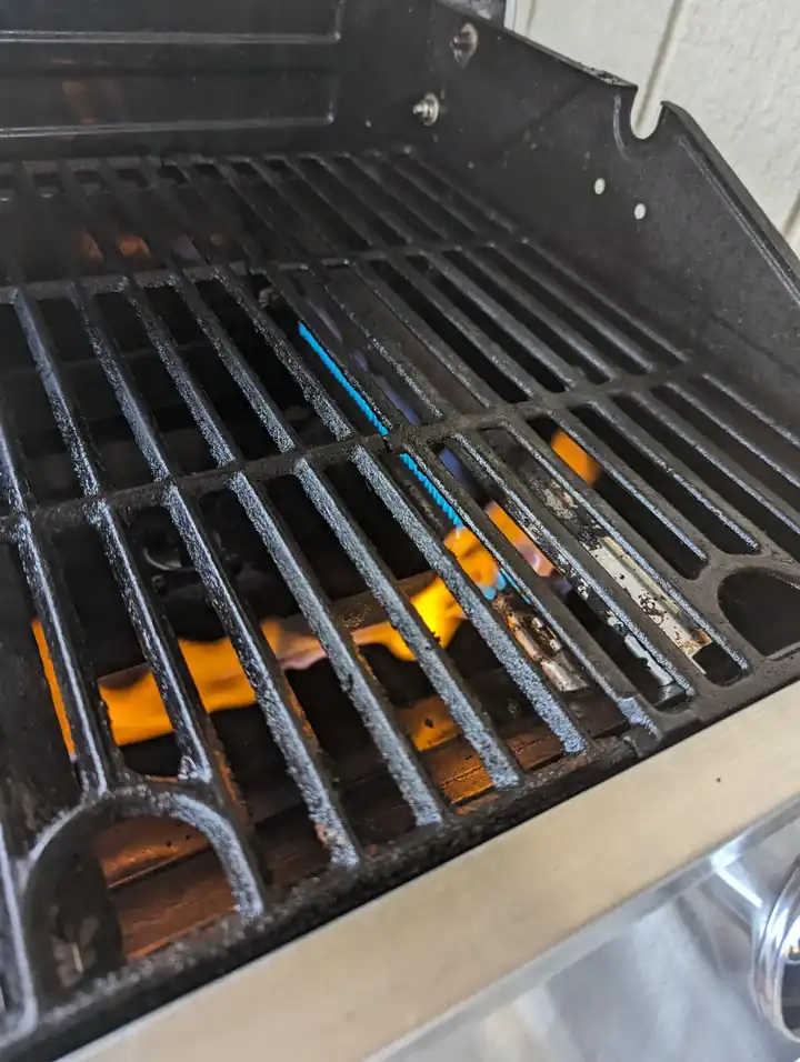 Gas grill burner producing an abnormal yellow flame